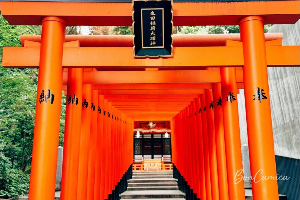 神戶生田稻荷大明神的朱紅色千本鳥居隧道與黑底金字匾額